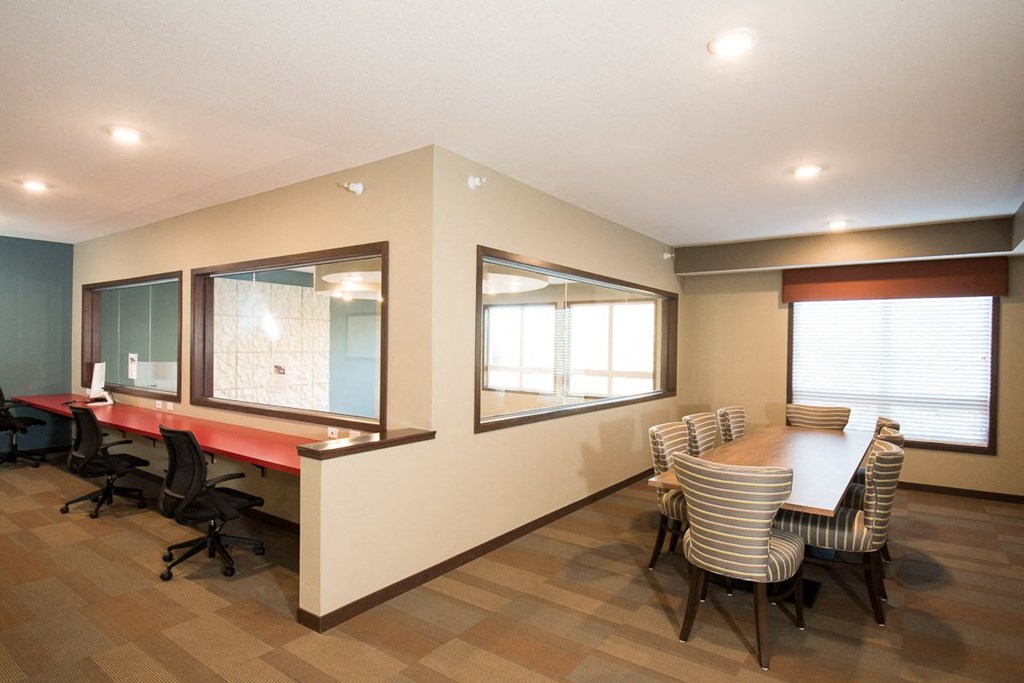 a conference room with a table and chairs and a window