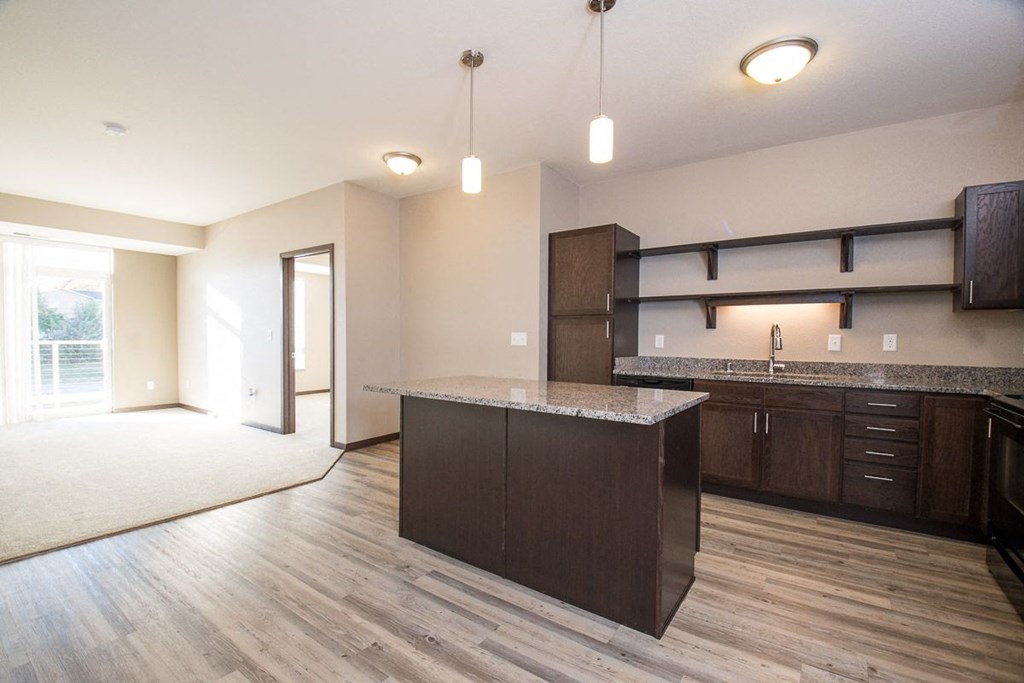 the view of a kitchen and living room in a new home