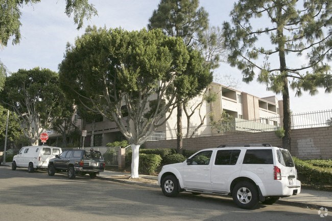 three cars parked on a street in front of a building