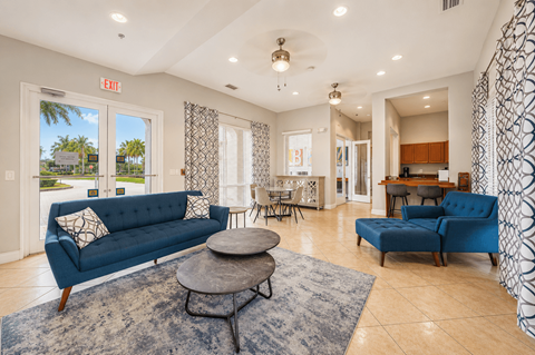 A living room with a blue couch and a coffee table.