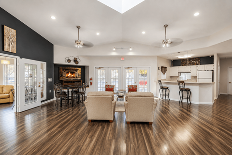 Clubhouse lounge with fireplace and kitchen bar at Northview Park Apartments, Sterling Heights, Michigan