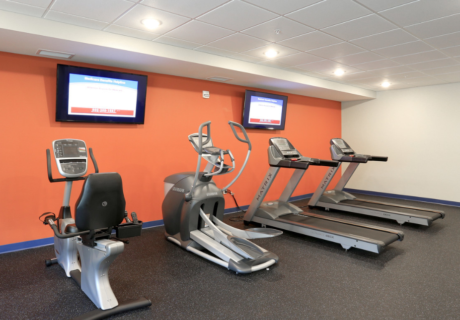 state of the art gym cardio equipment and a tv