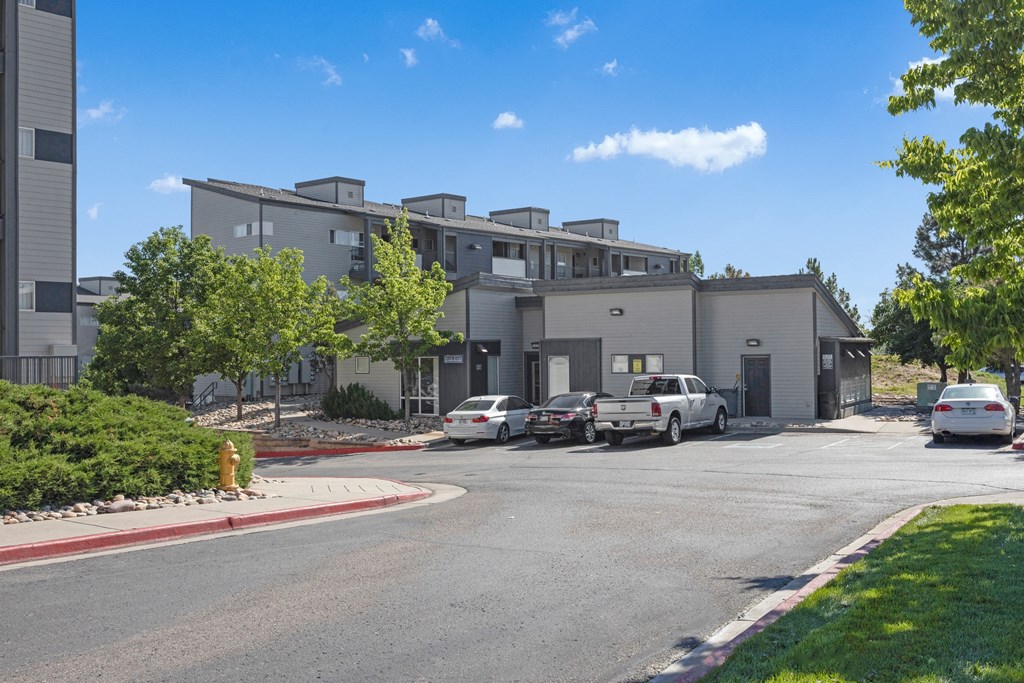 a large building with cars parked in front of it
