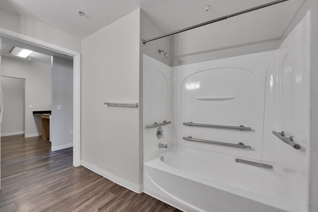 a bathroom with a tub and a shower in a house