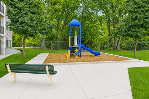 A playground with a blue tower and yellow slide.