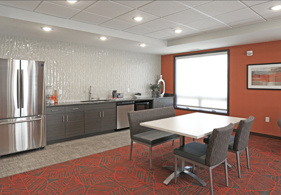 a kitchen with a table and chairs and a refrigerator
