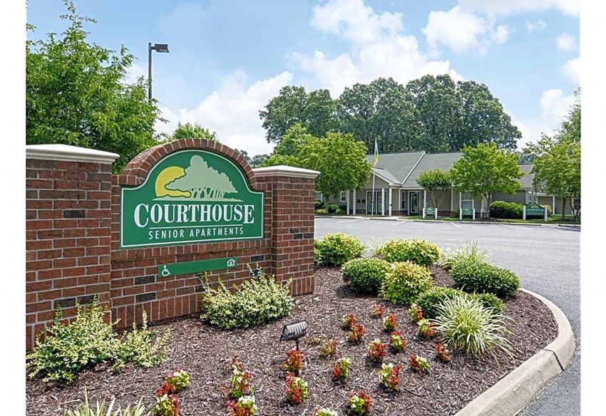 the front of the courthouse sign in front of a brick wall
