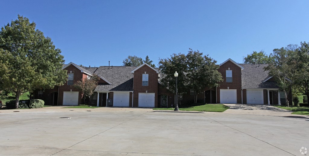a row of houses with white garage doors