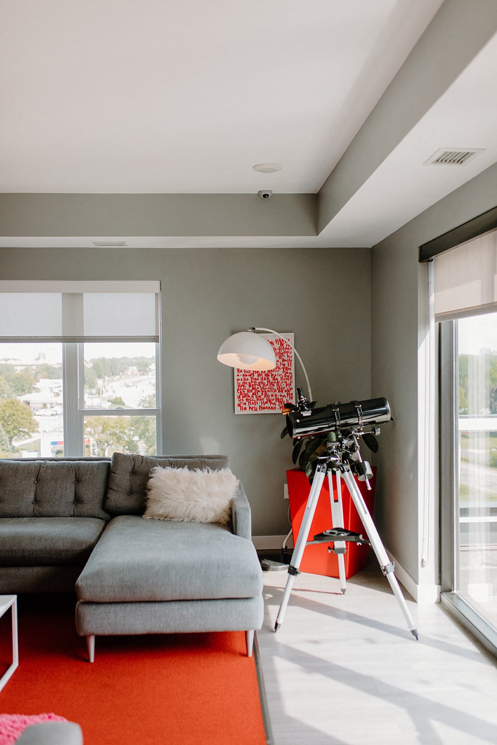 Living Room With Telescope at Hello Apartments, Minneapolis