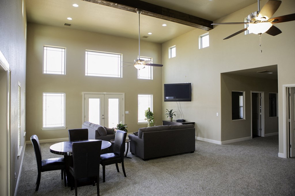 a living room with couches and chairs and a table