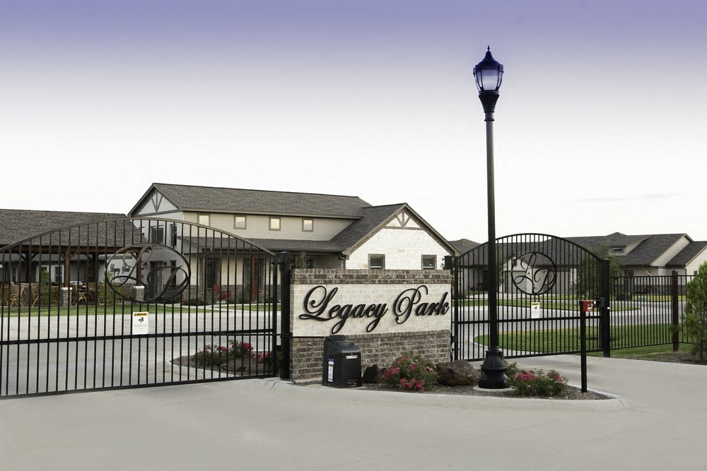 a house with a gate and a sign in front of it