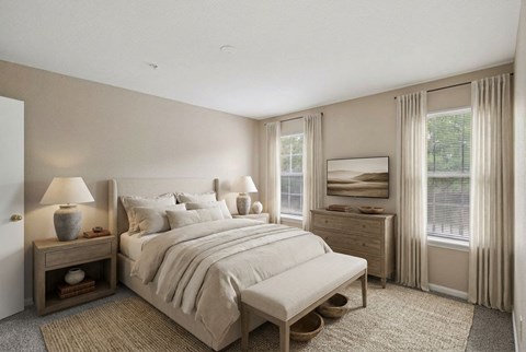 A bedroom with a large bed, nightstand, and window.