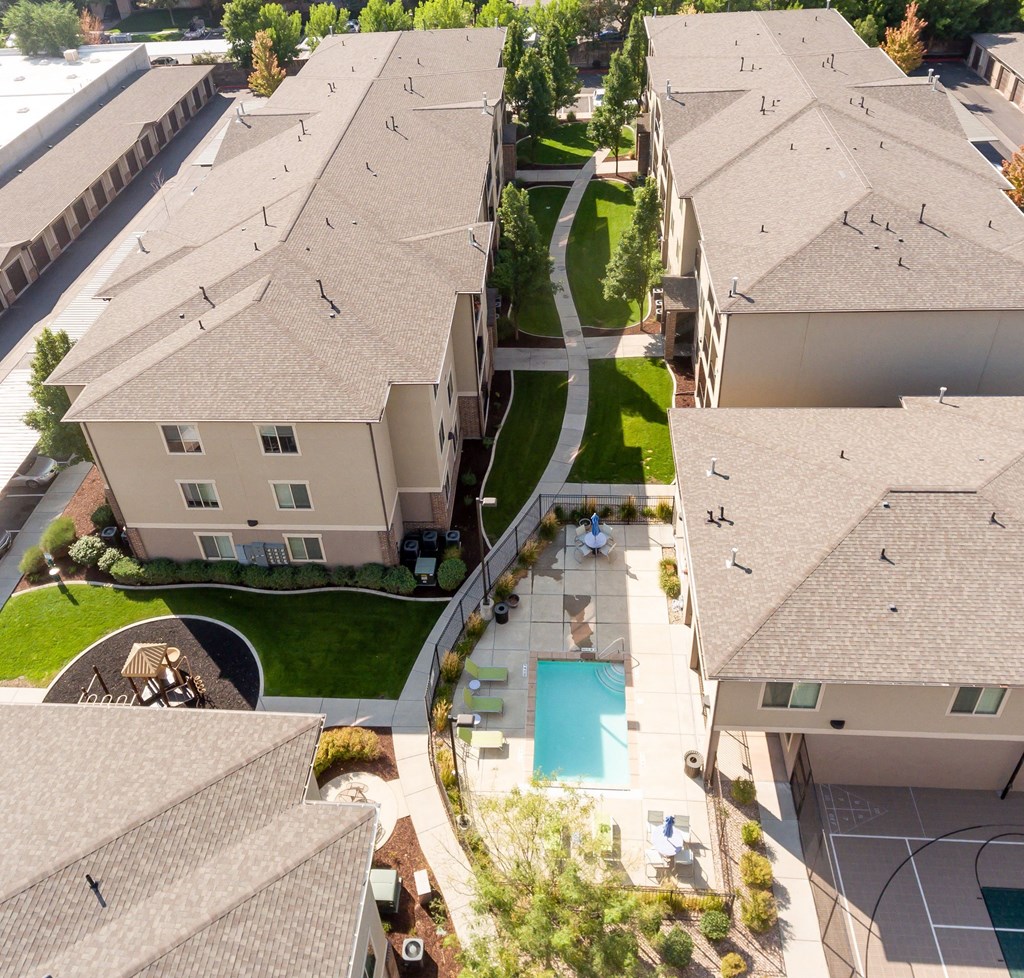 an aerial view of a neighborhood of houses with a swimming pool