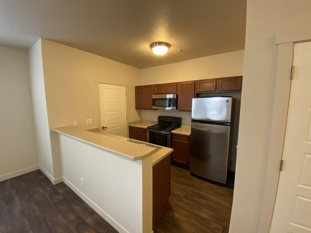 a kitchen with an island and stainless steel appliances