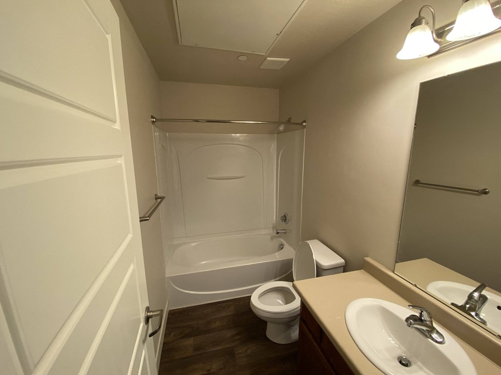 a small bathroom with a shower toilet and sink