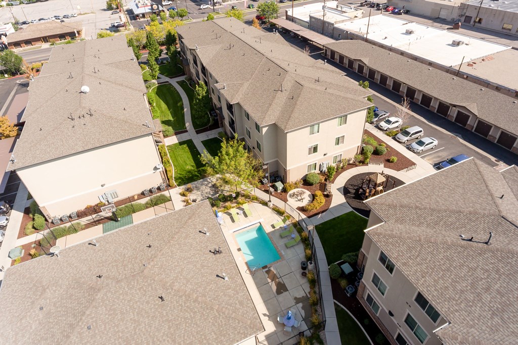 an aerial view of a neighborhood with houses and a swimming pool
