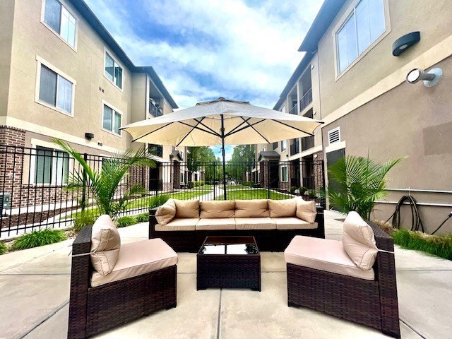a patio with a couch and an umbrella
