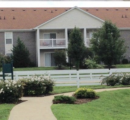a house with a white fence in front of it