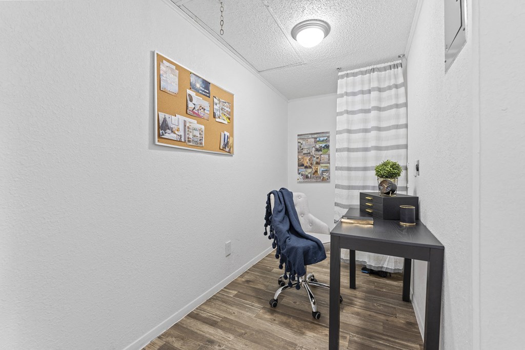 an office with a desk and a chair and a window