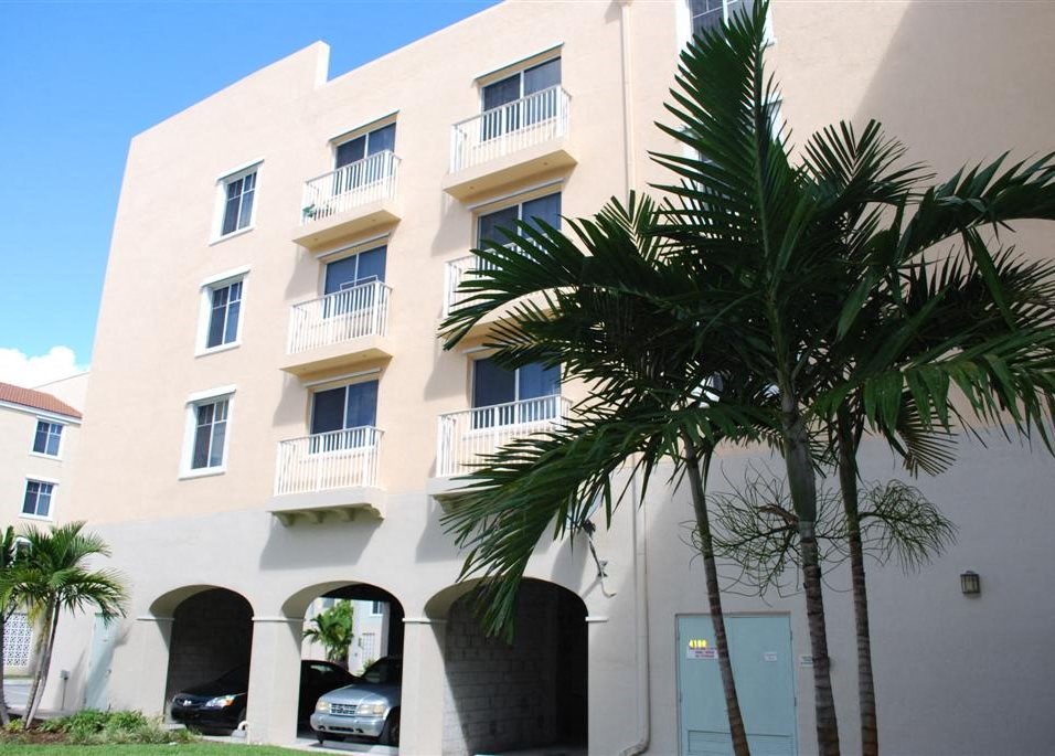 a building with palm trees in front of it