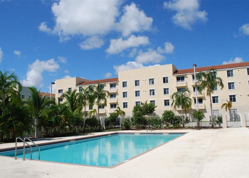 a swimming pool in front of an apartment building