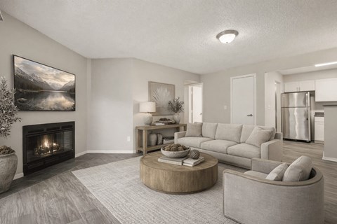 A modern living room with a fireplace and a large painting on the wall.