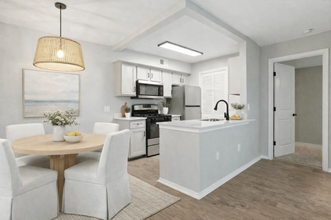 A modern kitchen with a dining table and chairs.