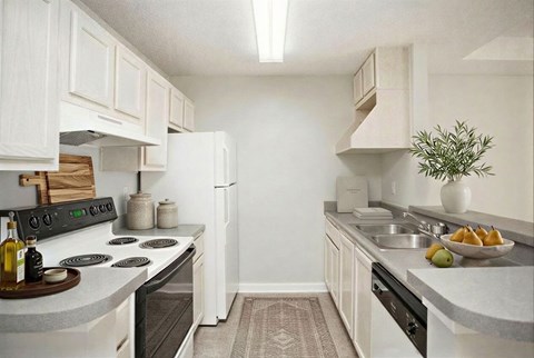 A kitchen with white cabinets and a black stove top.