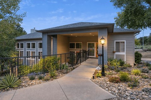 A house with a grey roof and a black fence.