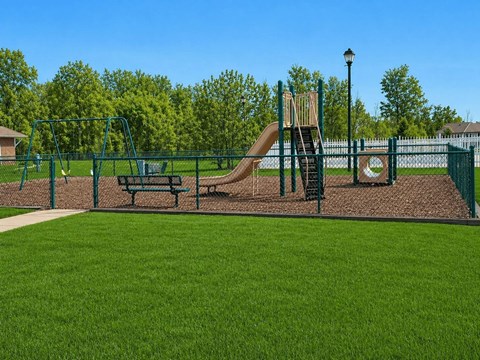 Playground area with slides and swings at Arbors at Georgetown Apartments, Lansing, MI 48911