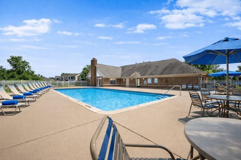 Outdoor swimming pool with sundeck and clubhouse at Arbors at Georgetown Apartments, Michigan
