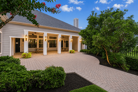 A house with a grey roof and a grey brick walkway.