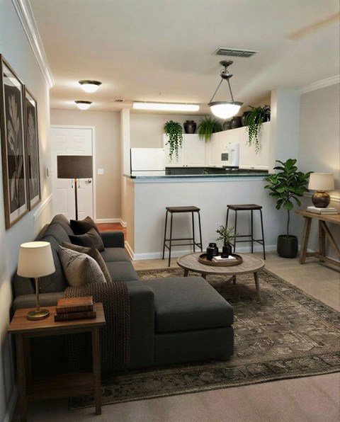 A living room with a grey sofa, a wooden side table, and a rug.