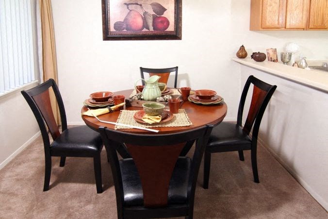 a dining room table with plates and bowls on it