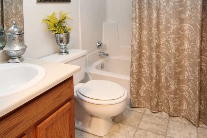 a bathroom with a toilet and a sink and a shower curtain