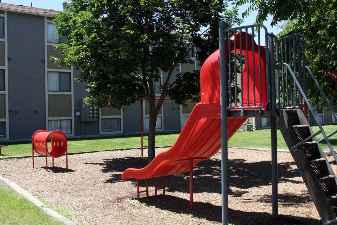 a slide at a playground in a park