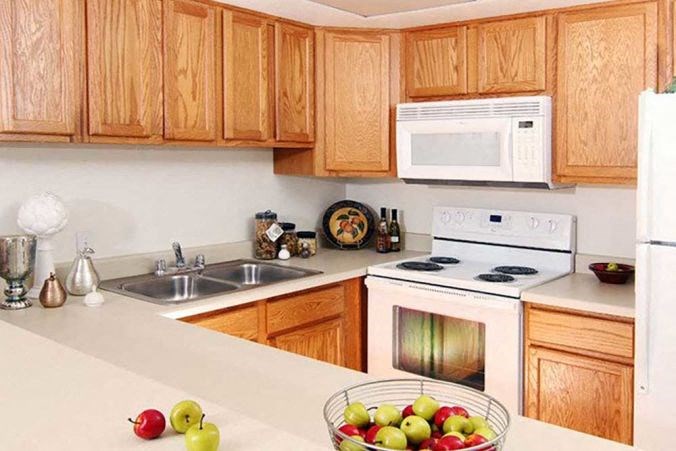 a kitchen with a bowl of fruit on the counter