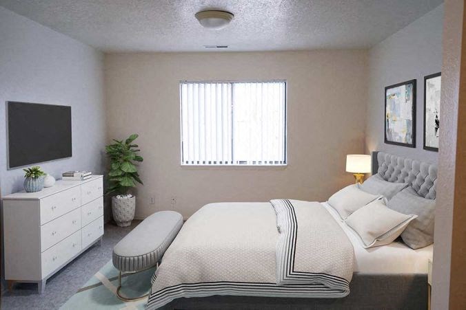 a white bedroom with a bed and a television