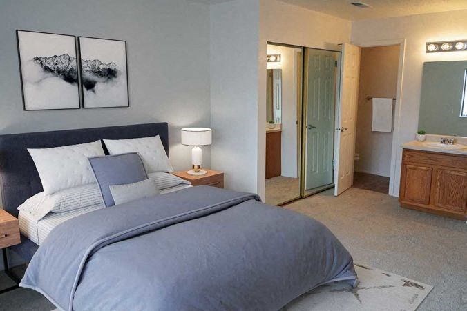 a bedroom with a large bed and a mirror