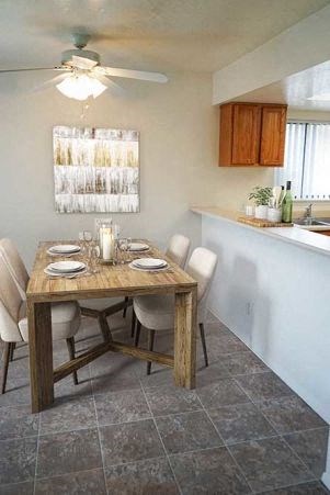 a dining room with a table and chairs