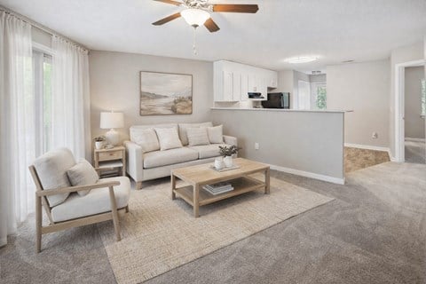 A living room with a ceiling fan and a painting on the wall.