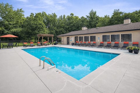 Resort style swimming pool with lounge chairs at Davidson Homes Apartments, Concord