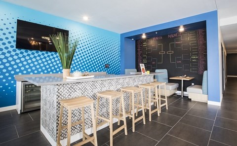 Resident bar area with tournament bracket board at Hello Apartments, Minneapolis, MN 55427