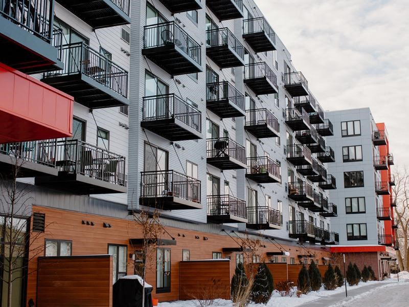 A modern apartment building with balconies at Hello Apartments, Minneapolis