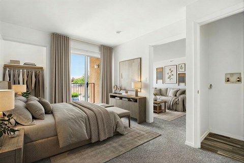 A bedroom with a large bed and a view of the outdoors through the window.