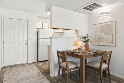 A small dining room with a table set for two.