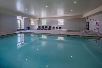a swimming pool with chairs around it in a hotel room The Beckstead, South Jordan, UT, 84095