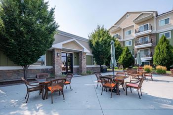 our apartments have a large patio with tables and chairs