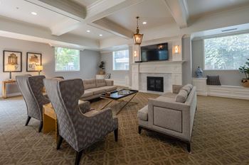 a living room with couches and chairs and a fireplace