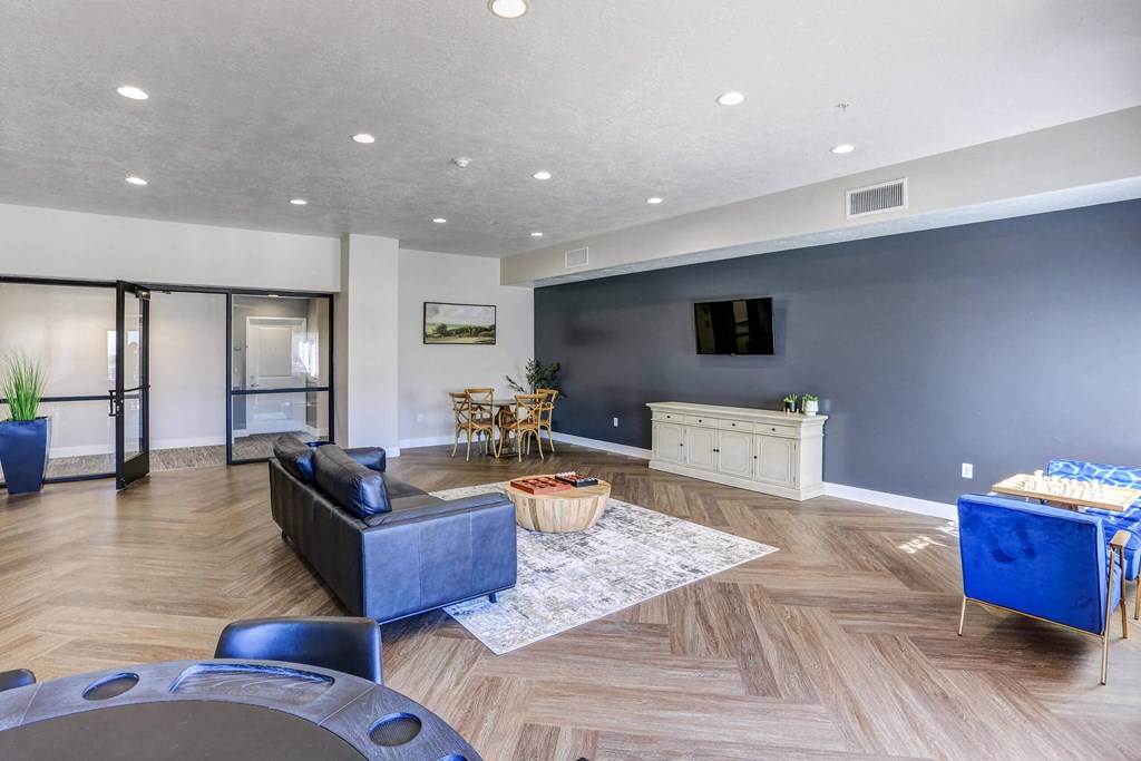 a living room with blue furniture and a blue accent wall at The Beckstead, South Jordan, 84095